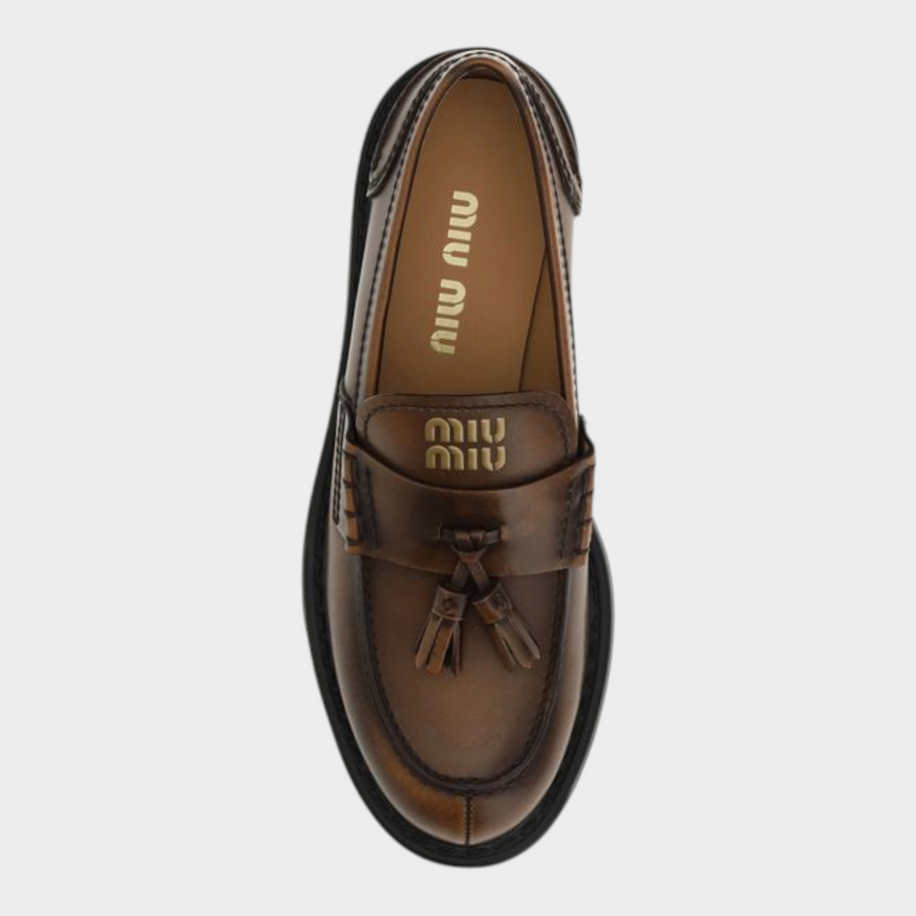 Esmire & Co Miu Miu brown calf leather platform loafers with tassel detail and topstitching, top view.