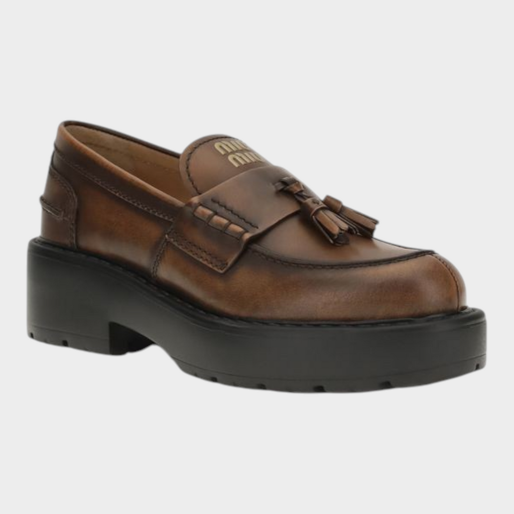 Esmire & Co Miu Miu brown calf leather platform loafers with tassel detail, rounded toe, and thick lug sole.