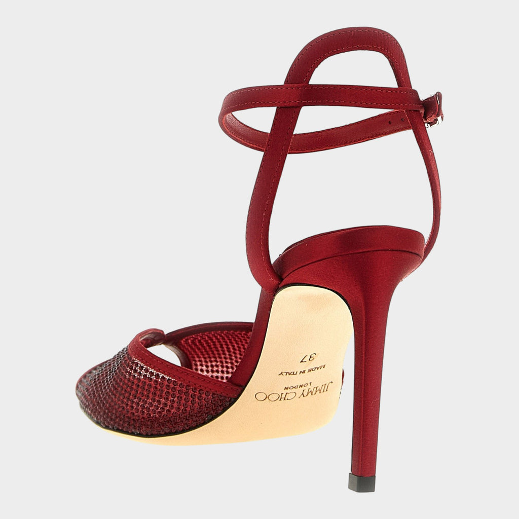 Esmire & Co red lamb leather stiletto sandals with micro crystals, satin accents, and an ankle strap.