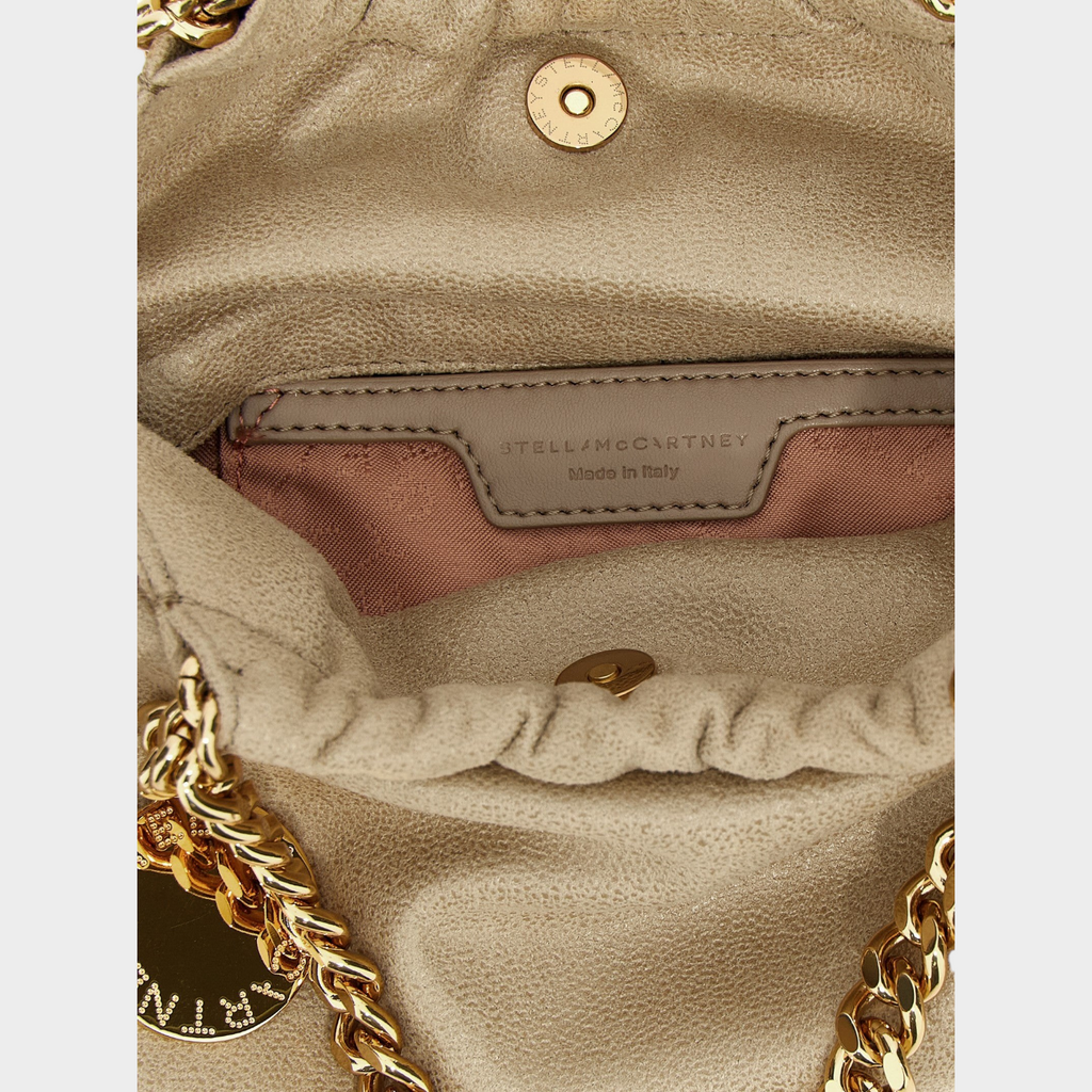 Interior of Esmire & Co Stella McCartney beige polyester Falabella crossbody bag with gold chain and logo tag