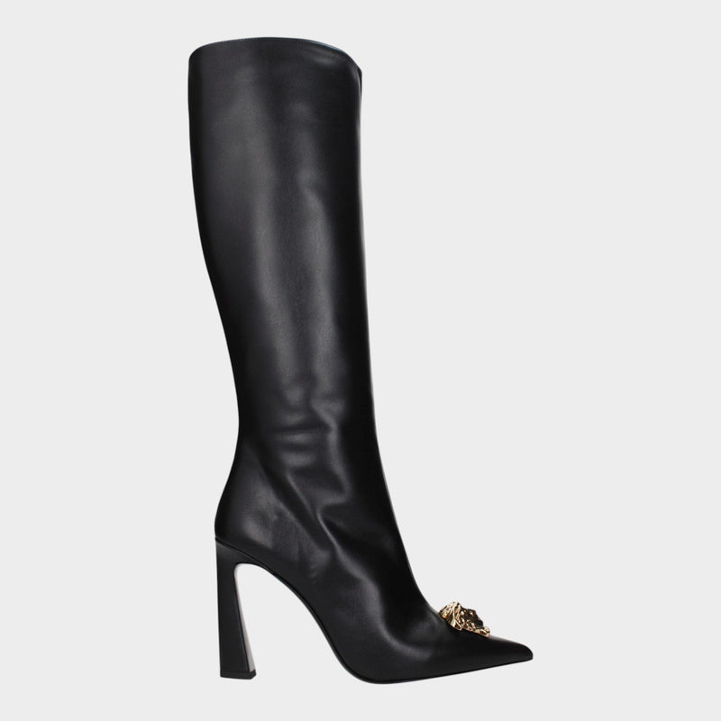 Esmire & Co black leather high heel boots by Versace featuring a gold front detail and a sleek pointed toe design.