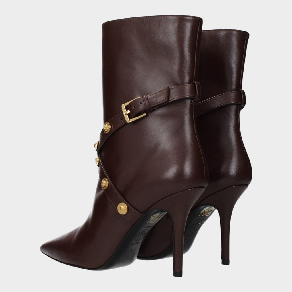 Esmire & Co Versace chocolate brown leather ankle boots with pointed toe, gold hardware, and sculpted high heel