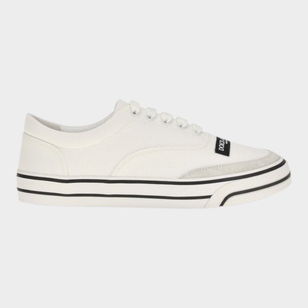 Esmire & Co white canvas low top sneakers with black striped rubber sole and branded label detail